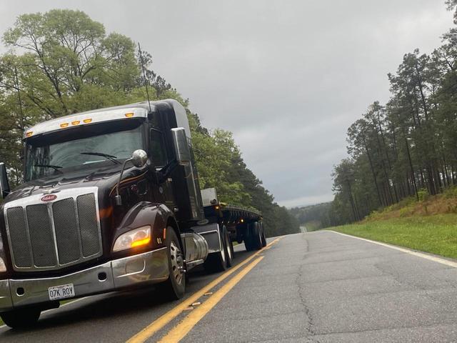 Peterbilt with flatbed on a two-lane road