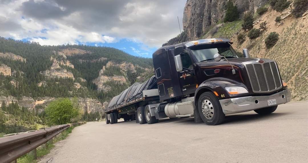 Covey Logistics flatbed on a mountain highway